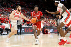 Wisconsin basketball guard AJ Storr attempts a shot while being defended by Ohio State guard Jamison Battle