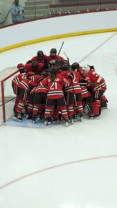 The St. Lawrence Saints huddle around their goal prior to playing a physical battle in the NCAA Tournament with the Wisconsin Badgers